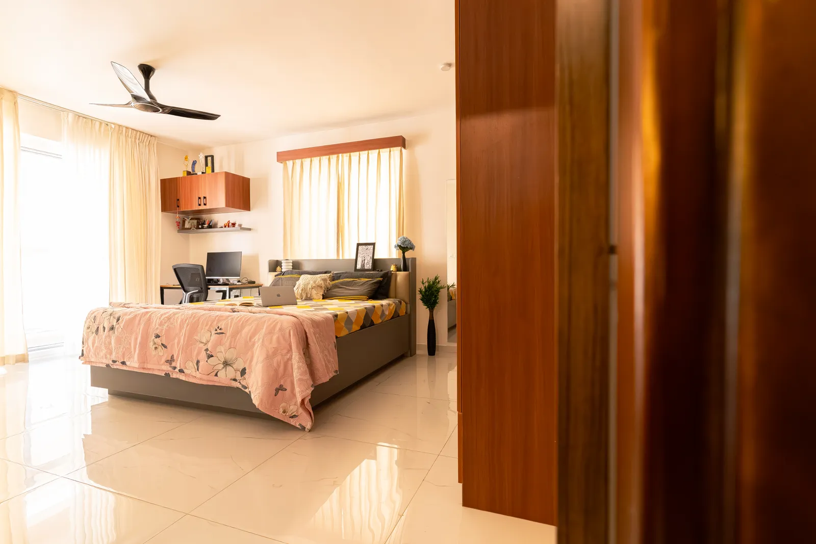 Bedroom with teak-finish wardrobe and wall storage — Karthik's Residence